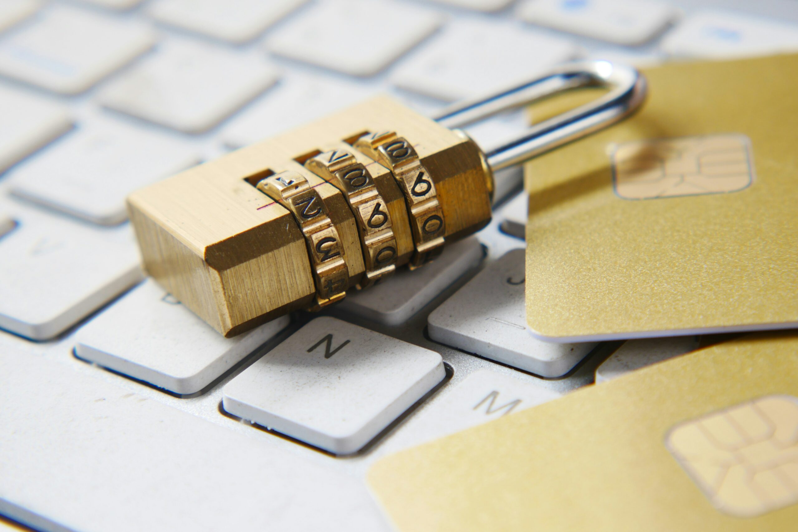 Combination lock and credit cards on top of a keyboard